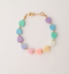 "If you would like to add gold filled hardware to a bracelet, please use this link to purchase it along with the bracelet. You will need to purchase one for EACH bracelet you would like to add gold filled hardware to. https://www.etsy.com/LittleLovliesShop/listing/860546443/gold-filled-upgrade?utm_source=Copy&utm_medium=ListingManager&utm_campaign=Share&utm_term=so.lmsm&share_time=1598757365437 Rainbow Heart Bracelet. These colorful pastel beads are aligned in a rainbow pattern a Pastel Bracelet Jewelry As Gift, Mother's Day Heart Beads Bracelets, Mother's Day Everyday Heart Bead Bracelets, Mother's Day Bracelets With Heart Beads, Dainty Pastel Jewelry For Gift, Dainty Pastel Jewelry As Gift, Pastel Dainty Jewelry For Gift, Dainty Pastel Jewelry Gift, Adjustable Heart Beads Jewelry For Birthday