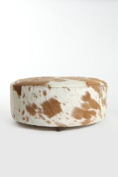 a brown and white cow print dog bed