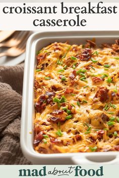 a casserole dish with bacon and green onions in it on a white plate