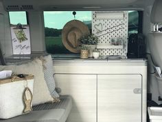 the interior of a camper van with various items on the counter and in the back