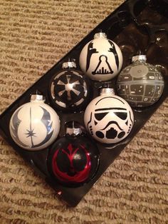 star wars ornaments are sitting on the floor next to each other in an ornament tray