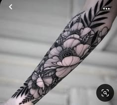 a black and white flower tattoo on the arm