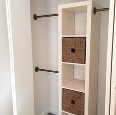 an empty closet with baskets on the shelves