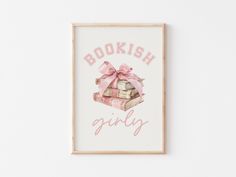 a framed bookish girl poster with pink ribbon and stack of books on it's side