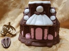 there is a small chocolate cake with icing on it and other decorations around it