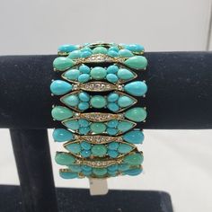 Adorn Your Wrist With The Vibrant Charm Of This Neiman Marcus Turquoise Beads With Rhinestones Stretch Bracelet, A Stylish Accessory That Seamlessly Blends Bold Colors And Dazzling Details. The Bracelet Showcases Rich Turquoise Beads, Accented By Sparkling Rhinestones, Creating A Striking Contrast Against The Lustrous Gold Tones. With A Generous 2-Inch Width, This Stretch Bracelet Makes A Bold Statement, Capturing Attention With Its Vibrant Colors And Elegant Design. The Stretch Feature Ensures Elegant Turquoise Jewelry With Rhinestones, Elegant Turquoise Beaded Bracelets For Party, Elegant Turquoise Crystal Bracelet For Party, Adjustable Turquoise Bracelet With Gemstone Accents, Elegant Turquoise Beaded Stretch Bracelet, Elegant Turquoise Crystal Bracelet, Neiman Marcus Jewelry, Turquoise Bracelets, Gold Stretch Bracelet