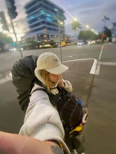 a woman is taking a selfie on the street