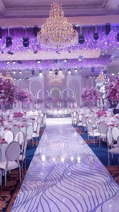 an elaborately decorated ballroom with chandeliers and tables