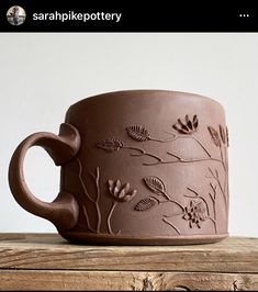 a coffee cup sitting on top of a wooden table