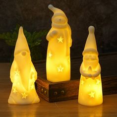 three small christmas lights sitting on top of a wooden table