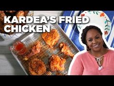 a woman standing in front of a tray with fried chicken on it and the words kadrea's fried chicken