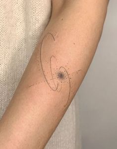 a person with a tattoo on their arm that has circles and dots all over it