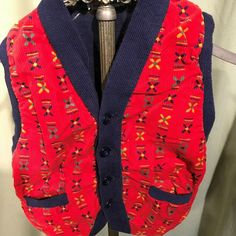 "This is a sweet vintage, toddler's sweater vest from the 50s. Label reads, Wee Men, Styled by Kaynee\". Tagged a size 3. Chest measures 21\", please see measurements below. Made of blue knit with a red print corduroy front. Buttons down the front & has 2 small pockets. The vest is in good condition. No soil, stains. No damage. Too cute! Measurements were taken with the garment laying flat. Please measure your child or a similar garment that fits your child well!! Vintage sizes run smaller t Vintage Cotton Sweater Vest For Winter, Vintage Red Sweater Vest For Fall, Red Vintage Sweater Vest For Fall, Red Cotton Retro Vest, Red Retro Cotton Vest, Retro Red Cotton Vest, Retro Winter Sweater Vest, Retro Red Winter Vest, Red Retro Winter Vest