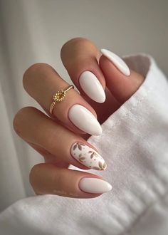 Embrace the clean girl aesthetic with these 25 simple and chic white nail ideas! Whether you prefer minimalistic charm or more elaborate designs, there's something for everyone. We just love these creamy almond shaped nails with beige flower art. Kutek Disney, Milky Nails, Nagel Tips, Colorful Nails, Her Nails, White Nail Designs, Thanksgiving Nails, Elegant Nails, Nail Accessories