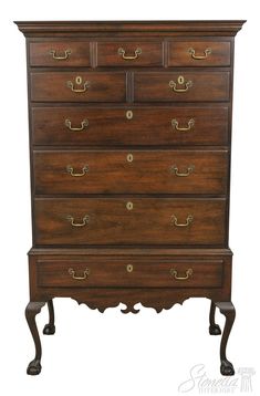 an old wooden dresser with brass hardware on the top and bottom drawers, against a white background