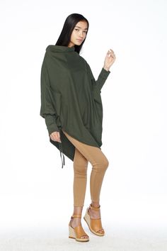 "🚚..ALL ORDERS ARE SHIPPED VIA DHL EXPRESS MAIL This batwing tunic is a very \"cool\" addition to any wardrobe! With a unique drawstrings on bottom hem of tunic provide plenty of options for changing the look. Cowl neckline, batwing sleeves with wide cuffed and oversized side pocket; can be worn layered over leggings, pants, or skirt for even more dramatic effects. * Pull-on style * Cowl neckline * Dropped shoulders * Long sleeves with wide ribbed cuff * Oversize side pocket * Asymmetrical hem Fall Tops For Layering With Asymmetrical Hem, Fall Tops With Asymmetrical Hem For Layering, Fall Layering Tops With Asymmetrical Hem, Oversized Funnel Neck Sweater For Spring, Oversized Tops With Asymmetrical Hem In Solid Color, Oversized Solid Color Tops With Asymmetrical Hem, Winter Plain Top With Asymmetrical Hem, Casual Solid Color Poncho For Fall, Asymmetrical Tops For Layering In Fall