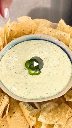 a bowl filled with guacamole surrounded by tortilla chips