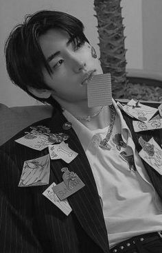 black and white photograph of a man with paper on his face sitting in a chair