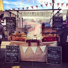 an outdoor stand selling food and other items