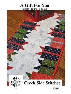 a quilted table runner is shown with the words, a gift for you on it