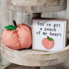 two pumpkins sitting on top of a wooden chair next to a sign that says you've got a peach of my heart