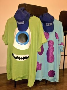 two t - shirts with monsters on them are hanging up