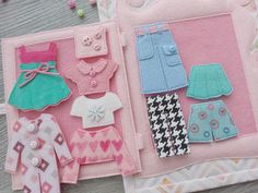 there are many different items made out of felt on the table, including clothes and buttons