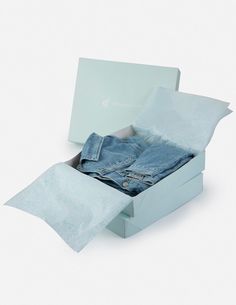 an open box with two pairs of jeans in it