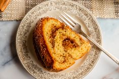 a piece of cinnamon bundt cake on a plate with a fork next to it