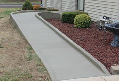 a cement walkway in front of a house