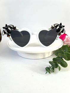 🖤Funky unique bat statement sunglasses  🖤These awesome shades are perfect for adding some WOW factor to your outfits!  🖤The frames are white plastic heart shape and they have tinted black lenses. On the ends they have two 3d black bats as well as a few metal stars and sparkly rhinestones.  🖤Perfect for fancy dress, festivals etc.  🖤Completely unique like no others  you will find!  🖤UV protection 🖤All my glasses come in a black pouch to keep them safe, please also handle with care as with all sunglasses they can break easily if miss handled. 🖤Checkout the full collection of Sunnies here :  https://www.etsy.com/uk/shop/AlexisExclusive?ref=s2-header-shopname (Colours may vary slightly due to different screens and monitors) White Heart-shaped Sunglasses With Gradient Lenses, White Heart-shaped Sunglasses With Tinted Lenses, Heart-shaped White Sunglasses With Tinted Lenses, Trendy Halloween Sunglasses With Gradient Lenses, Fun Black Halloween Sunglasses, Trendy Tinted Sunglasses For Costume Party, Gothic Accessories, Heart Sunglasses, Black Bat