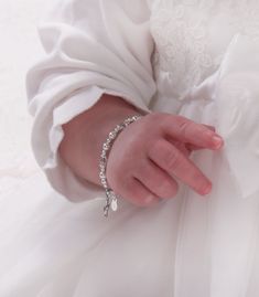 "This precious baptism and christening bracelet is made of sterling silver and high-end simulated pearls with sparkling high-end crystals and accented with a sweet dainty sterling silver cross charm for babies and infants (0-12 months adjustable). Celebrate these cherished moments with this keepsake she will treasure forever! Bracelet measures 4 - 4.5 inches. Made in the USA Make is extra special by adding a personalized initial charm so it's unique just for her. Add a silver-plated jewelry box Elegant Adjustable Bracelet For Baptism, Elegant Adjustable Bracelets For Baptism, Elegant Adjustable Pearl Bracelet For Baptism, Elegant Adjustable Rosary Bracelet For First Communion, Elegant Silver Pearl Bracelet For Baptism, Adjustable Silver Pearl Bracelet For Baptism, Elegant Bracelet Jewelry For Baptism, Elegant Hypoallergenic Rosary Bracelet For Baptism, Adjustable Silver Name Bracelet For Baptism