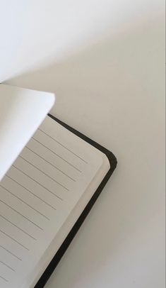 an open notebook sitting on top of a white table