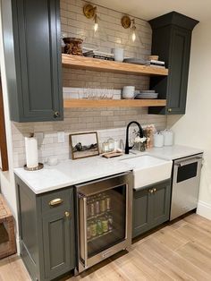 a kitchen with gray cabinets and white counter tops