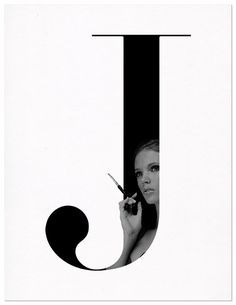 a black and white photo of a woman holding scissors in front of the letter j