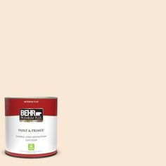 the behr paint and primer is shown in an open, beige - colored tin