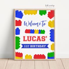 a welcome sign for lucas's 1st birthday with legos on it and the words, welcome to lucas's 1st birthday