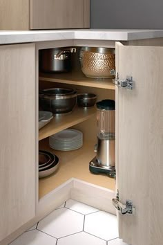 an open cabinet with plates and bowls in it