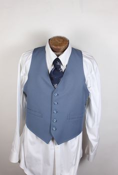 "ALL CLOTHING SALES ARE FINAL. How sharp is this vest, though? Wow. And guess what? It's reversible! Two vests in one. The one side is blue with two pockets, and the reverse is blue plaid. No smoke, damage or mildew. No tags. 36R chest. Measurements:  Chest: 36\" Length: 24\" Pair with many of the handsome ties available in the shop right now and save on shipping! I'm here to make you look good. What a fun item! Thank you for looking!" Vintage Fitted Sleeveless Outerwear, Retro Fitted Sleeveless Outerwear, Vintage Blue Sleeveless Outerwear, Fitted Sleeveless Vintage Outerwear, Fitted Blue Vest Outerwear, Classic Blue Cotton Vest, Fitted Vintage Blue Vest, Blue Fitted Vintage Vest, Retro Fitted Sleeveless Vest