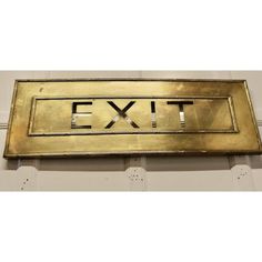 an exit sign mounted to the side of a wall