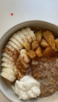 a bowl filled with oatmeal and sliced bananas