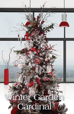 a white christmas tree with red and silver decorations