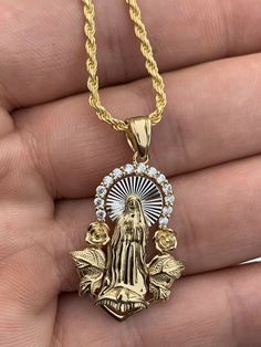 "Beautiful handmade Iced Out Floral Virgin Mary pendant 14k yellow gold over SOLID 925 SILVER. Roughly 1\" in size. Pendant weighs 5 grams! Super Icy cz adorns top of pendant Amazing handmade piece You can buy pendant alone or with choice of 2mm solid 925 silver (14k gold plated) chain. Chain is Made in Italy & comes in 16-30\" IF YOU ONLY WANT PENDANT, PLEASE SELECT \"0\" LENGTH Pendant will fit most chains up to 3mm thick Ships fast Let us know if you have any questions!" Dope Jewelry Accessories, Virgin Mary Pendant, Gold Chain With Pendant, Jewelry Accessories Ideas, Dope Jewelry, Jewelry Fashion Trends, Jewelry Lookbook, Girly Jewelry