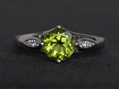 Welcome to my shop, you can find many beautiful gemstone jewelry here, and you also can ask for customized service. Main Stone: natural peridot, round cut 7X7mm, 1.4 caratsAccent Stones: czMetal: 925 sterling silver plated with rhodium. I also can provide metal options such as 14k solid yellow/white/rose goldSetting: four claw basket settingmore rings: https://www.etsy.com/shop/XCjewelryStudio?ref=hdr_shop_menuIt's a perfect gift for the person who was born in August(Birthstone), it's quite comf Elegant Lime Green Birthstone Promise Ring, Peridot Jewelry With Round Cut Center Stone, Peridot Jewelry With Center Stone In Round Cut, Round Cut Peridot Jewelry With Center Stone, Peridot Jewelry With Center Stone, Elegant Peridot Birthstone Ring, Peridot Jewelry With Gemstone Accents, Peridot Birthstone Ring With Accent Stones, Lime Green Peridot Promise Ring