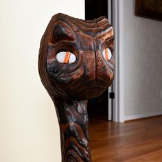 a close up of a cat statue on a wooden floor