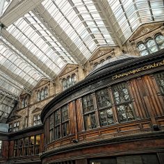 the inside of a building with many windows and glass roofing on it's sides