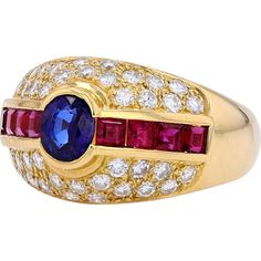 Marvel at the myriad of magnificence with this stunning 18K Yellow Gold Sapphire & Ruby Ring from our exquisite collection. Crafted to capture the essence of timeless elegance, this ring features a captivating Sapphire as its main stone, boasting a total carat weight of 1.58 Carats. Complementing the allure are dazzling Diamonds with a total weight of 0.73 Carats, adding a touch of brilliance to this already mesmerizing piece.The rich, warm tones of 18K Yellow Gold perfectly enhance the vivid colors of the gemstones, creating a harmonious and luxurious aesthetic. Whether worn as a symbol of your personal style or as a cherished heirloom, this ring exudes sophistication and grace.Indulge in the allure of this Estate Jewelry piece and embrace the enchanting beauty that transcends time and tr Luxury Multi-stone Diamond Gemstones, Luxury Multi-stone Sapphire Gemstones, Luxury Oval Ruby Ring, Luxury Oval Ruby Ring With Pave Setting, Luxury Round Cut Gemstones With Center Stone, Luxury Round Cut Center Stone Gemstones, Luxury Oval Multi-stone Diamond Ring, Luxury Ruby Rings With Gemstone Accents, Luxury Oval Sapphire Ring With Pave Setting