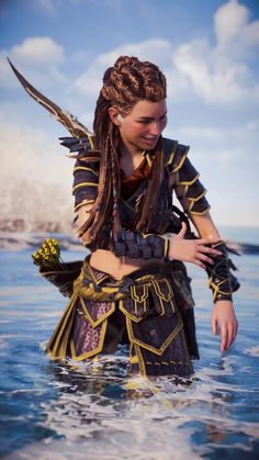 a woman with dreadlocks standing in the water wearing a costume and holding flowers