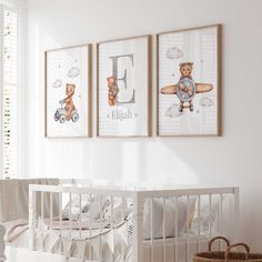 a baby's room with three framed pictures on the wall