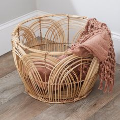 a basket with a blanket on the floor